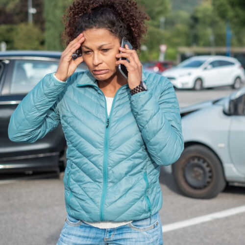 Image of a women on the phone after a car accident calling for a Car Accident Lawyer