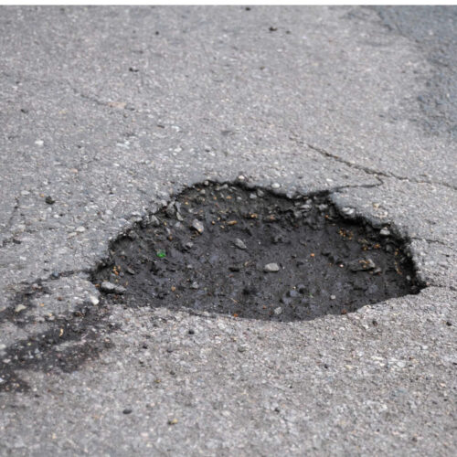 https://stensonlaw.com/wp-content/uploads/2022/11/Image-of-pot-hole-in-the-road-500x500.jpg